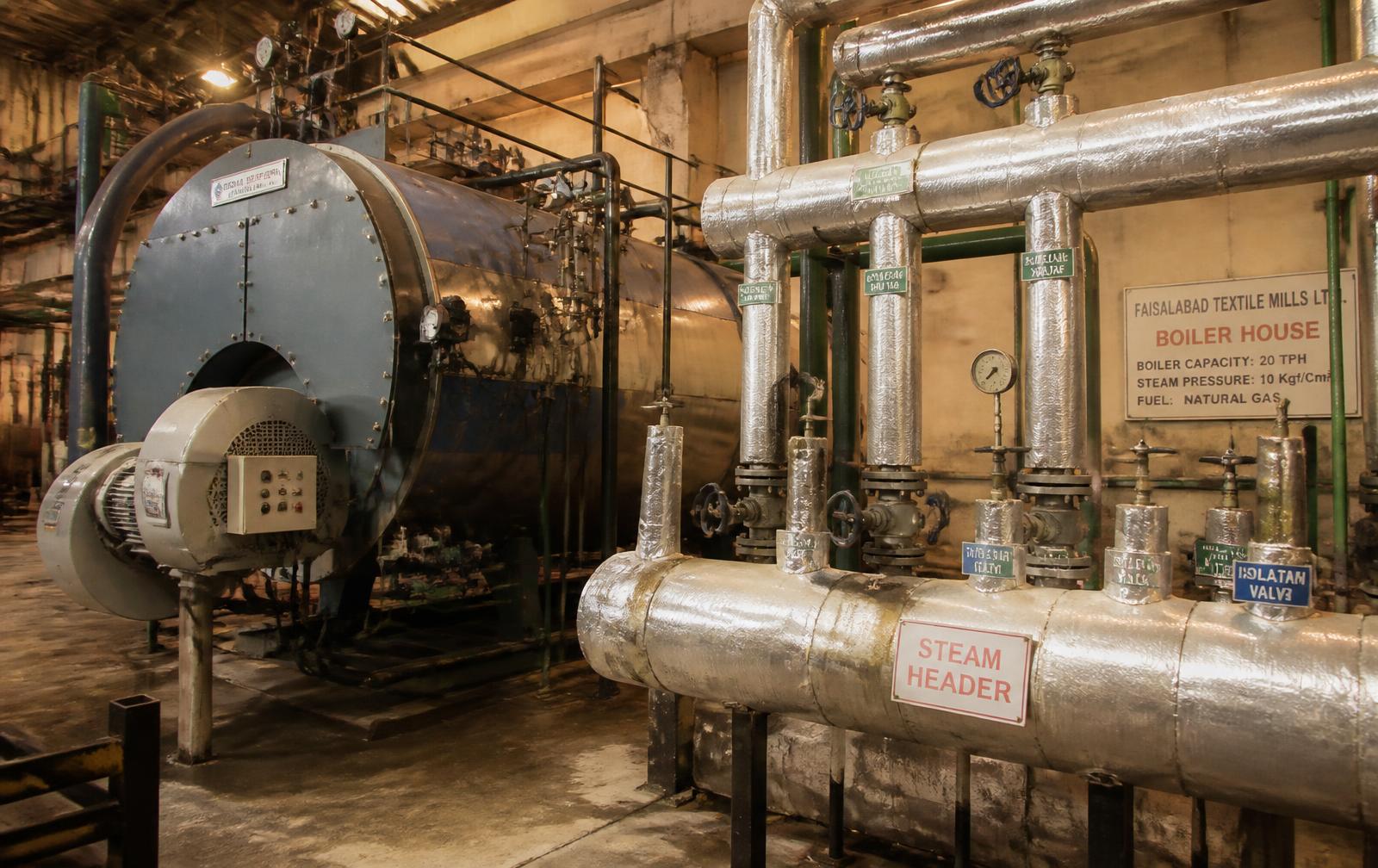 Boiler house with steam header and isolation valves in a textile mill